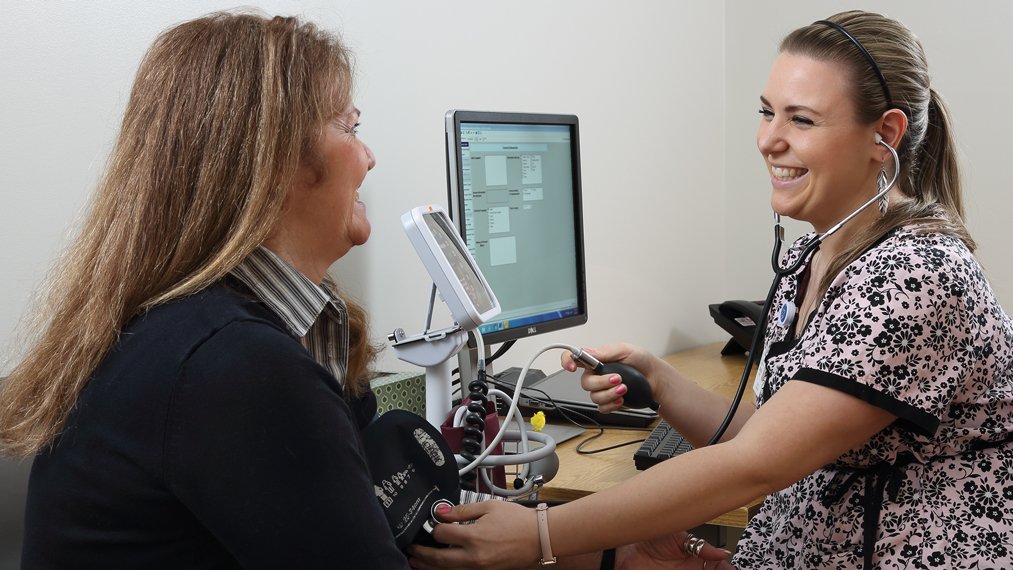 medical assistant taking blood pressure on a patient