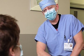 General surgeon talking to a patient in pre-op