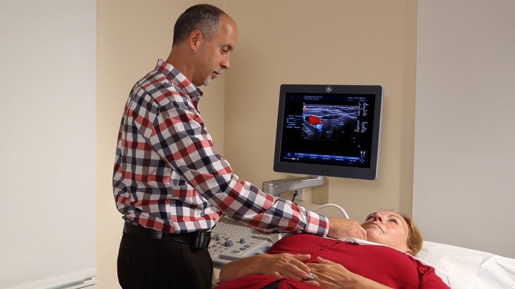 Dr. Phil Lapp examines a female patient